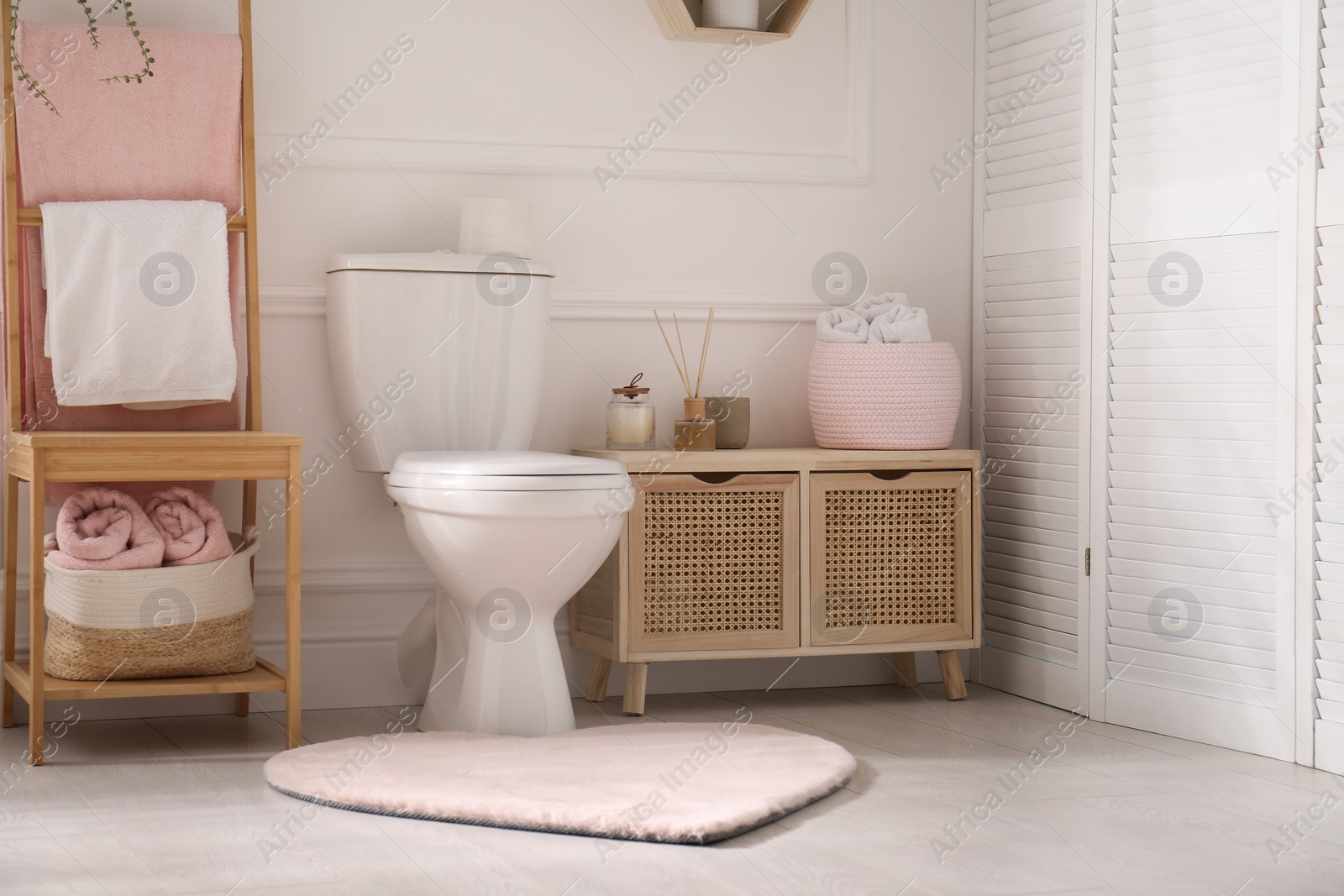 Photo of Stylish bathroom interior with toilet bowl and other essentials