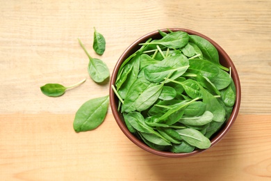 Fresh green healthy spinach on wooden table, top view