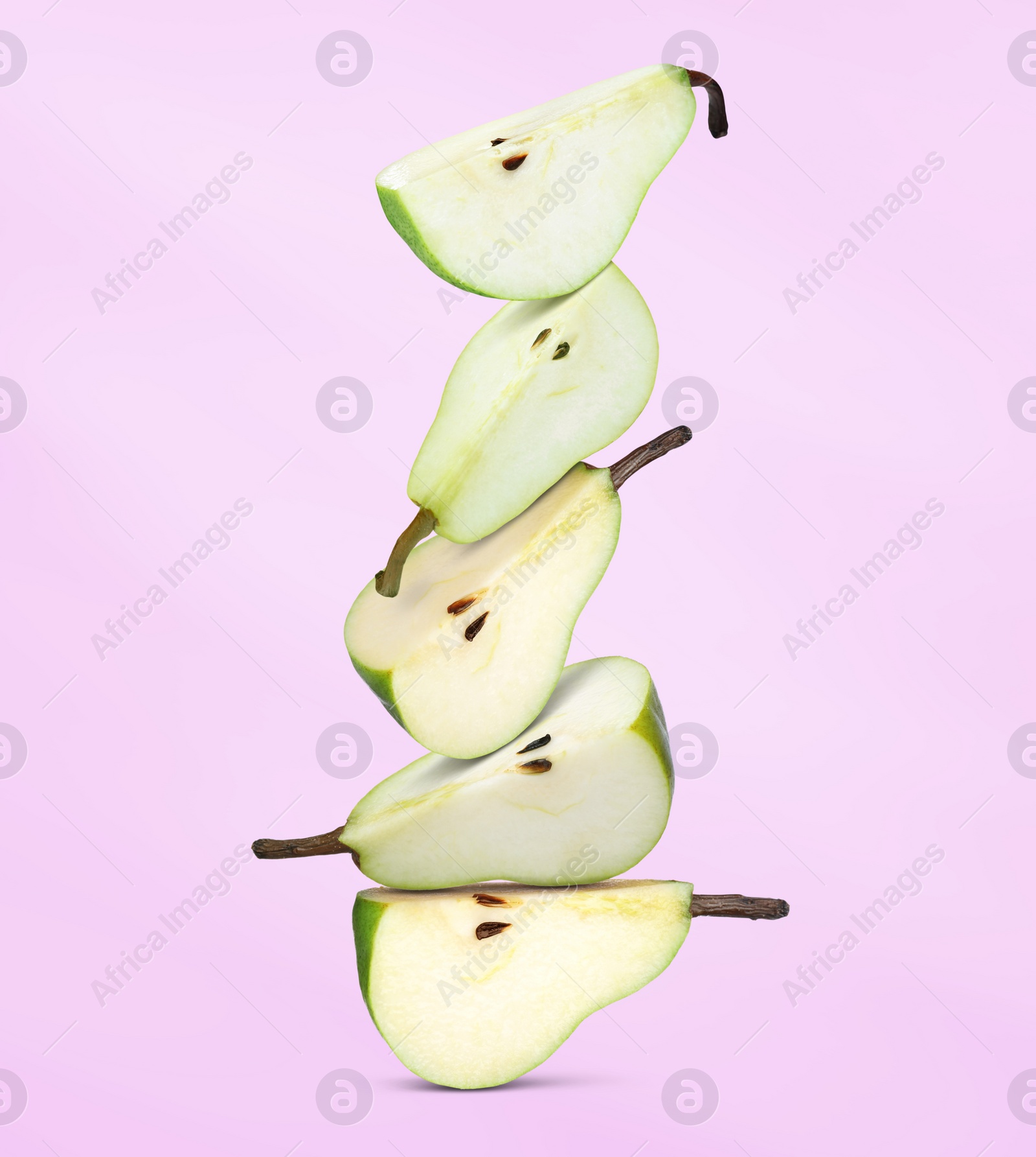 Image of Cut fresh ripe pears on pale violet background