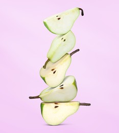 Image of Cut fresh ripe pears on pale violet background