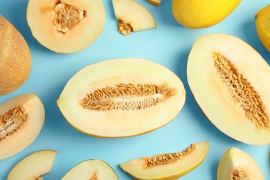 Photo of Flat lay composition with melons on color background