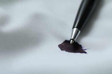 Pen and stain of black ink on white shirt, closeup. Space for text