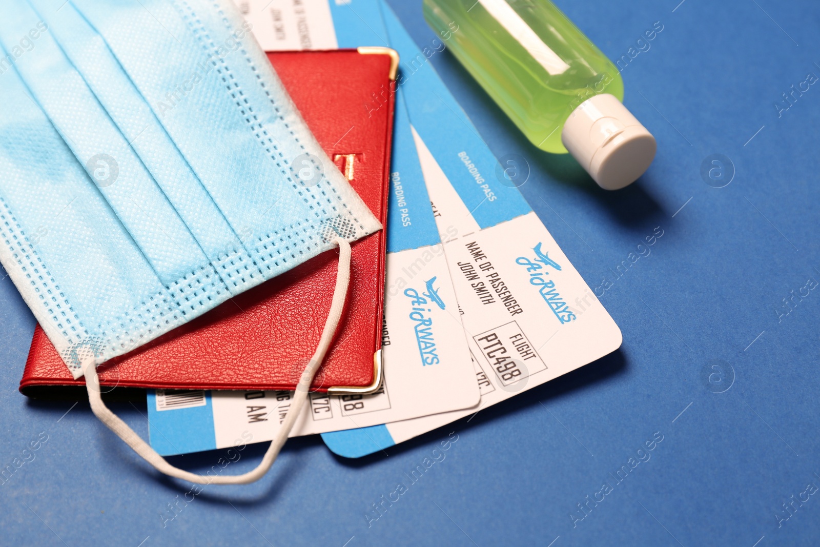 Photo of Composition with passport and protective mask on blue background, closeup. Travel during quarantine