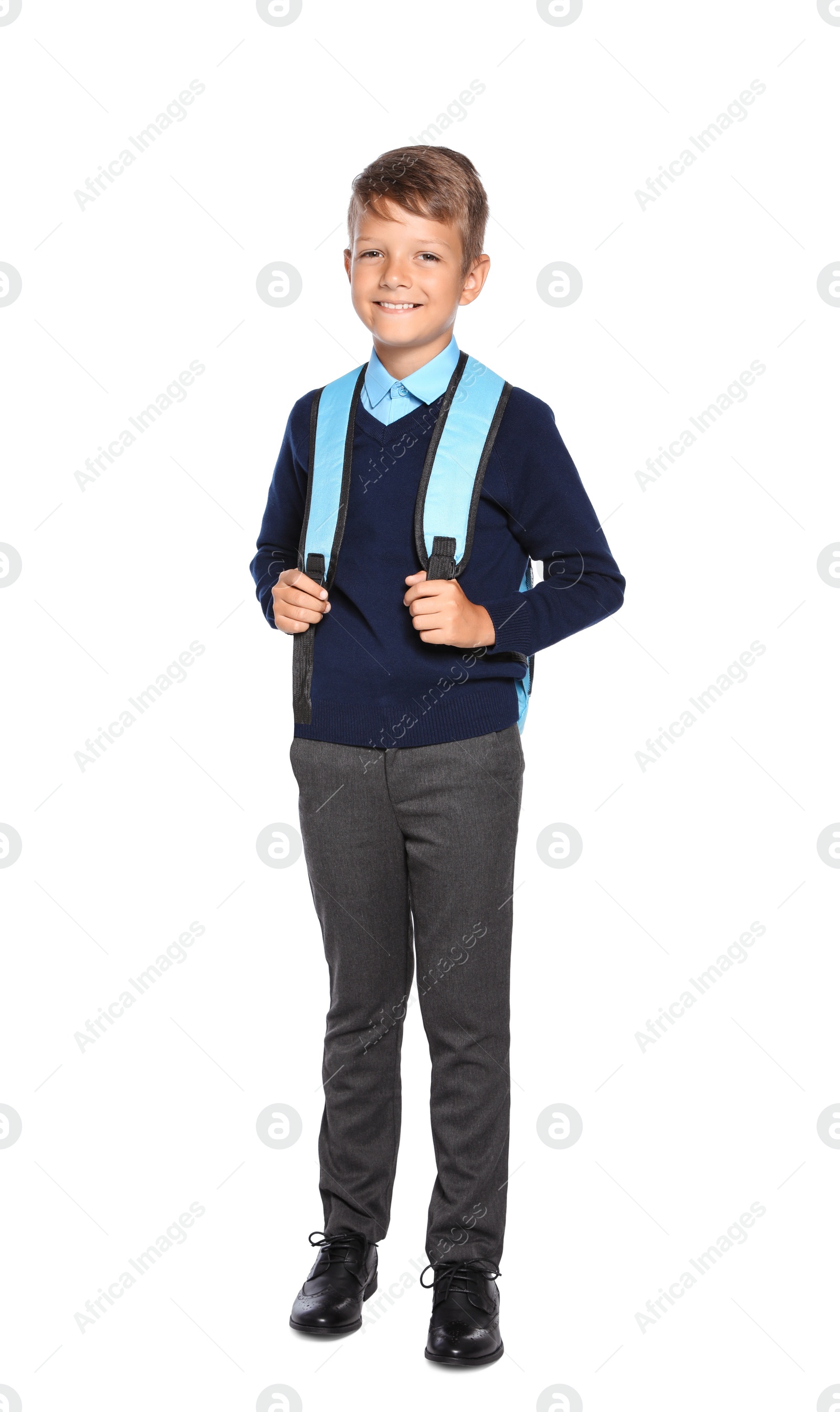 Photo of Little boy in stylish school uniform on white background