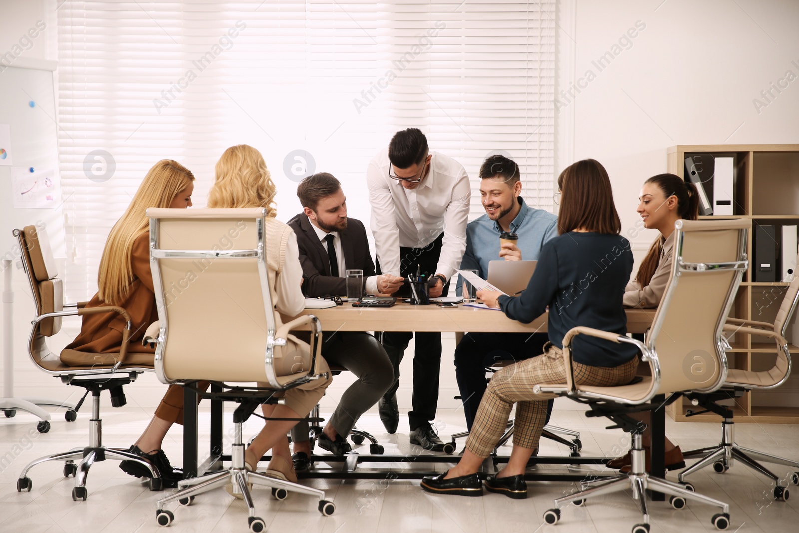 Photo of Businesspeople having meeting in office. Management consulting