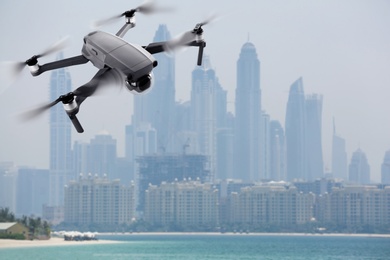 Image of Modern drone on blurred cityscape. Aerial survey