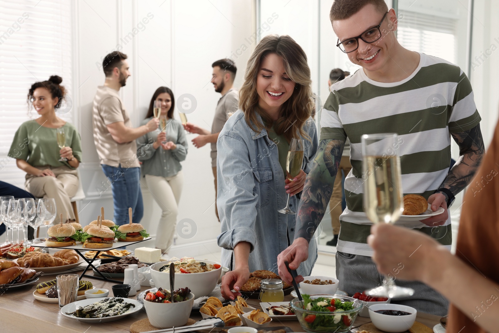 Photo of Group of people enjoying brunch buffet together indoors