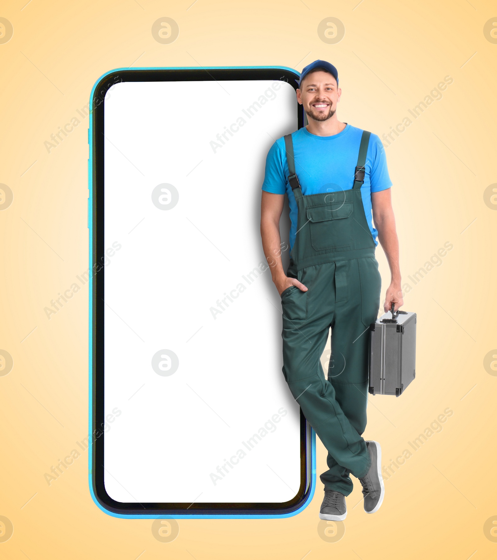 Image of Repair service - just call. Happy professional repairman holding toolbox and smartphone with blank screen on beige background, space for design