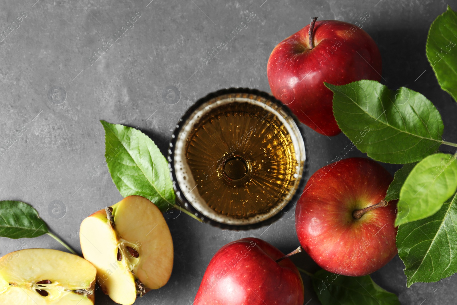 Photo of Flat lay composition with delicious apple cider on gray table