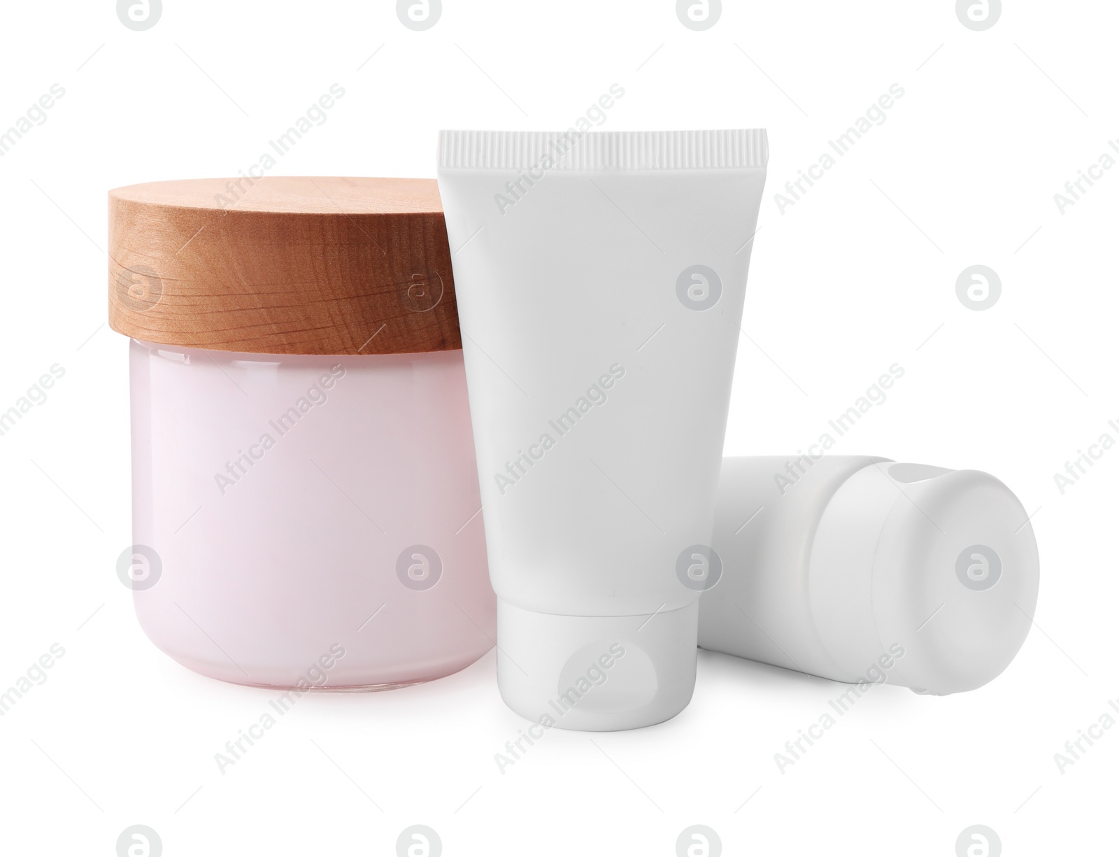 Photo of Jar and tubes of hand cream on white background