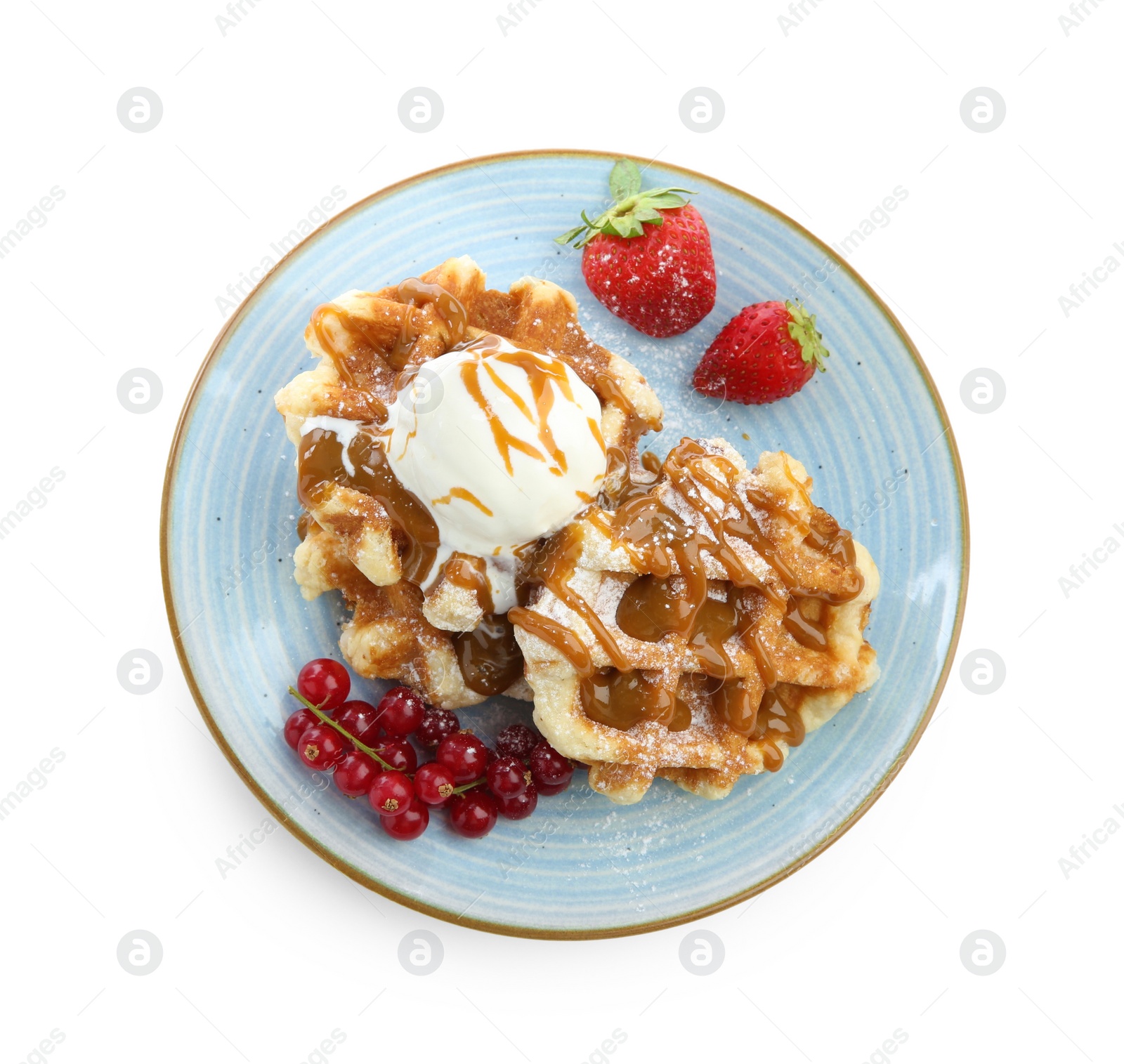 Photo of Tasty Belgian waffles with ice cream, berries and caramel syrup on white background, top view