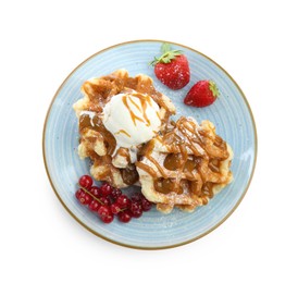 Photo of Tasty Belgian waffles with ice cream, berries and caramel syrup on white background, top view
