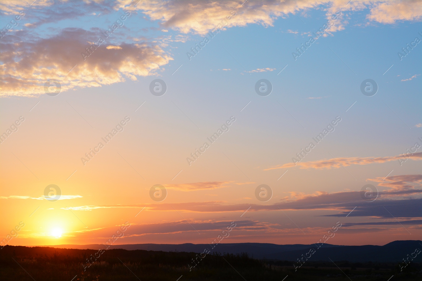 Photo of Picturesque view of landscape under beautiful evening sky with clouds at sunset