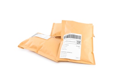 Photo of Padded envelopes on white background. Parcel delivery