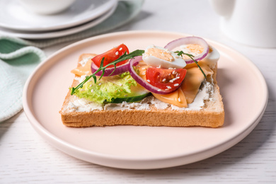 Photo of Delicious sandwich served on white wooden table, closeup