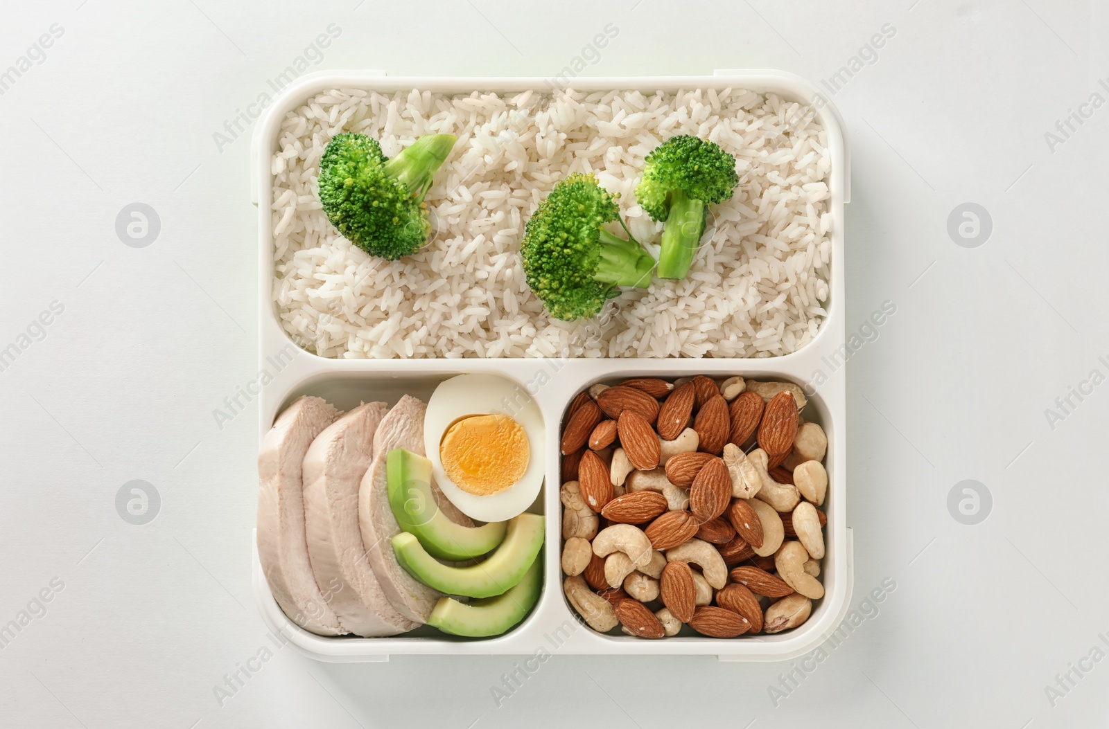 Photo of Container with natural healthy lunch on white background, top view. High protein food