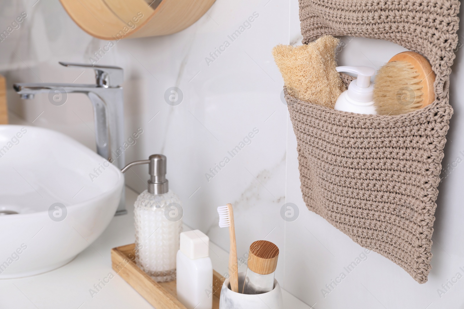 Photo of Countertop and storage with essentials in bathroom. Stylish accessory