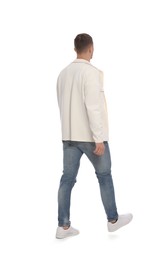 Man in casual outfit walking on white background, back view