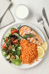 Plate with healthy food high in vegetable fats served on light wooden table, flat lay