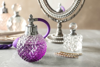 Photo of Different perfume bottles on dressing table, space for text