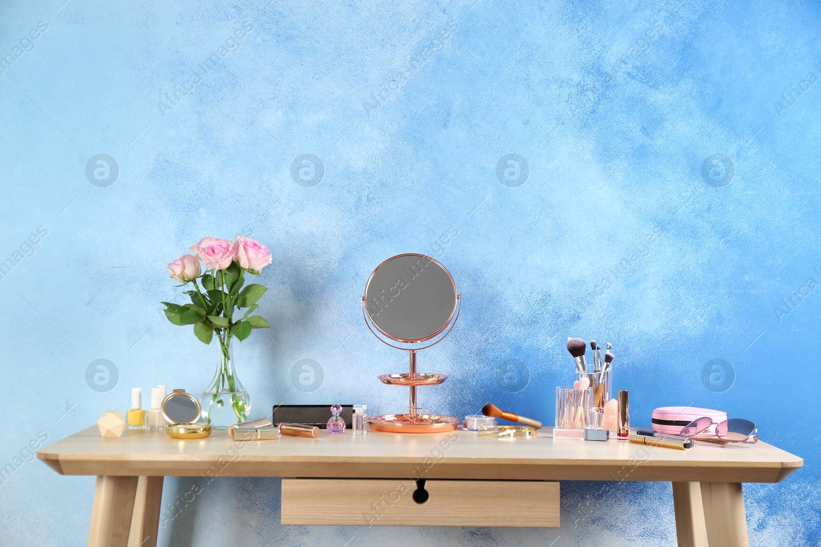 Photo of Dressing table with beauty accessories in room. Space for text