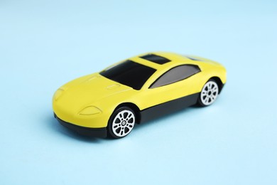 One yellow car on light blue background. Children`s toy