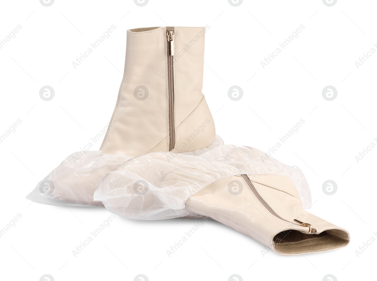 Photo of Women's boots in shoe covers isolated on white