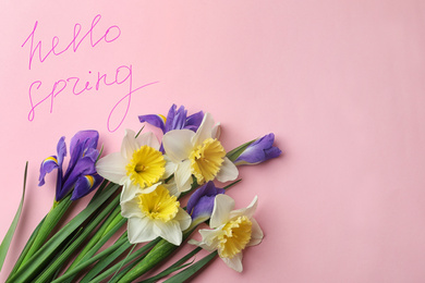 Photo of Words HELLO SPRING and fresh flowers on pink background, flat lay. Space for text