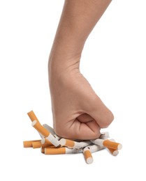 Photo of Stop smoking. Man crushing cigarettes on white background, closeup