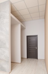 Photo of Empty office room with color walls and door. Interior design