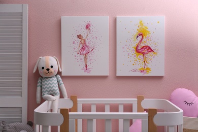 Photo of Beautiful pictures of flamingo and ballerina on pink wall in baby room. Interior design