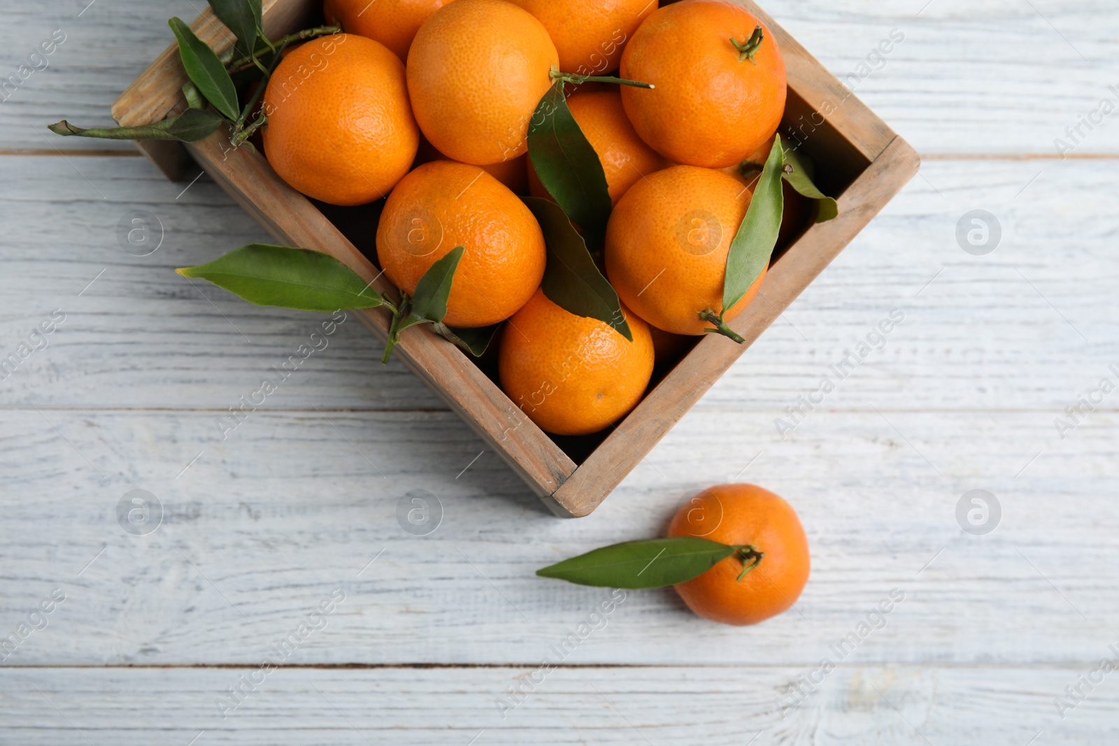 Photo of Crate with fresh ripe tangerines on wooden background, top view