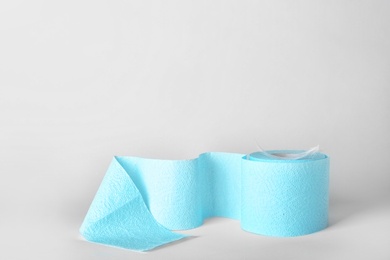 Photo of Roll of toilet paper with feather on white background. Space for text