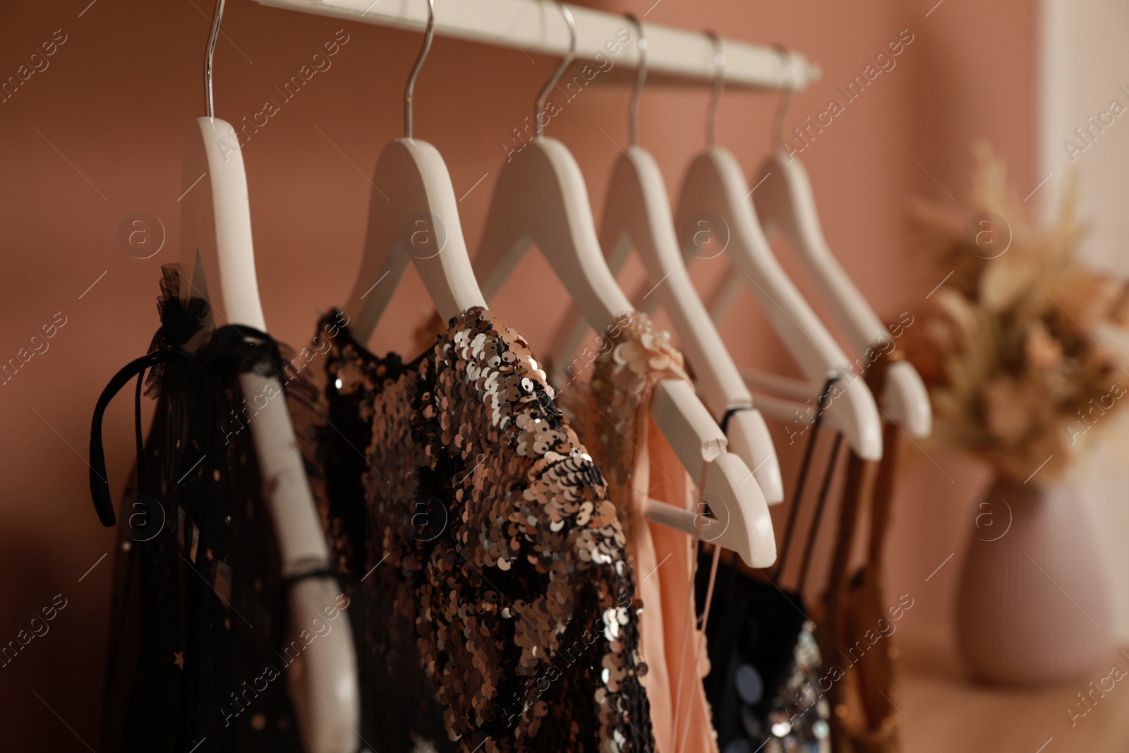 Photo of Collection of trendy women's garments on rack indoors, closeup. Clothing rental service