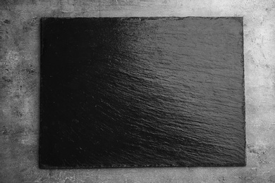 Black textured slate board on dark background