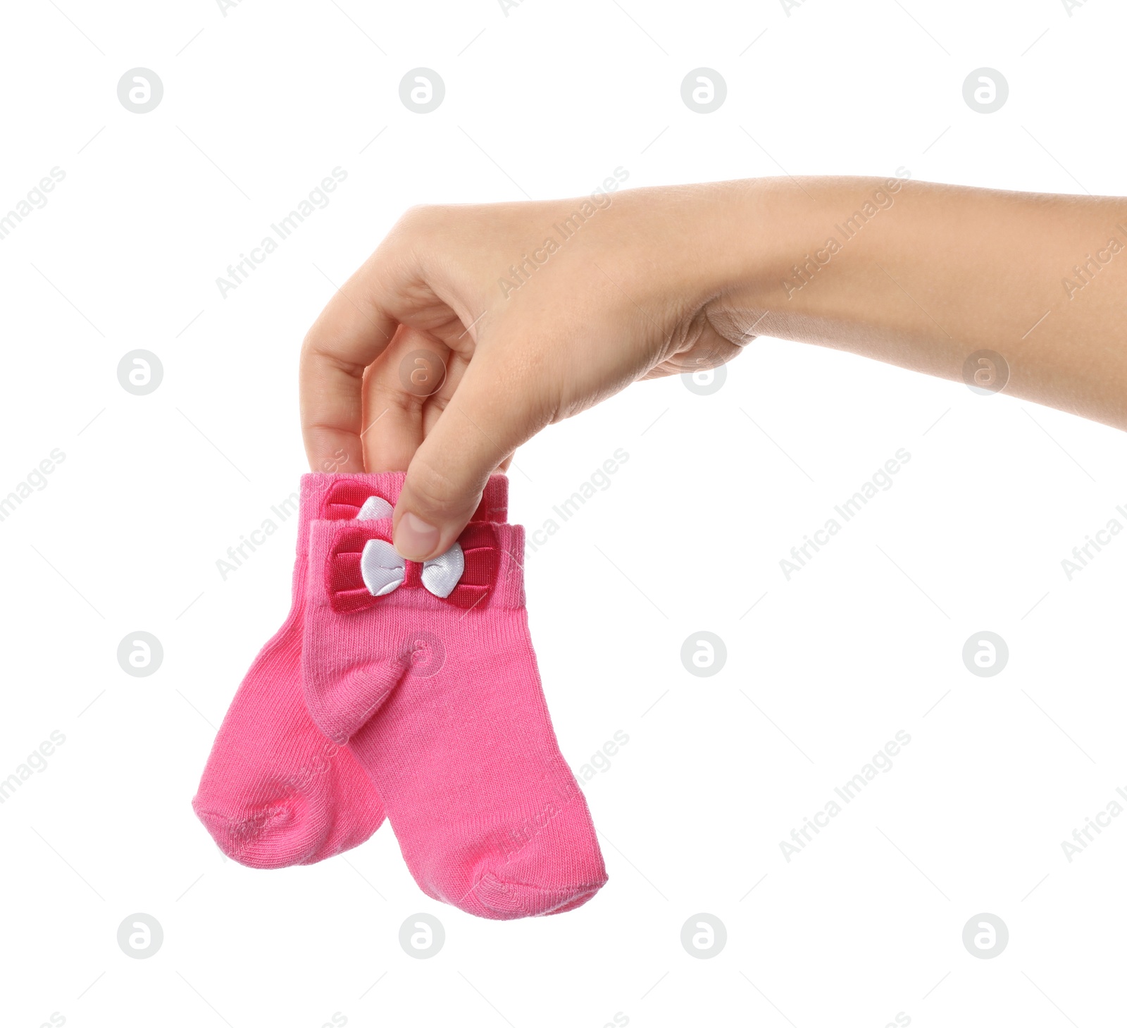 Photo of Woman holding pair of cute child socks on white background, closeup