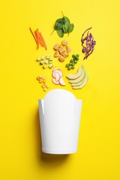Photo of Flat lay composition with ingredients for salad and paper container on yellow background