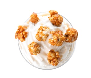 Photo of Glass of delicious milk shake with whipped cream and popcorn on white background, top view