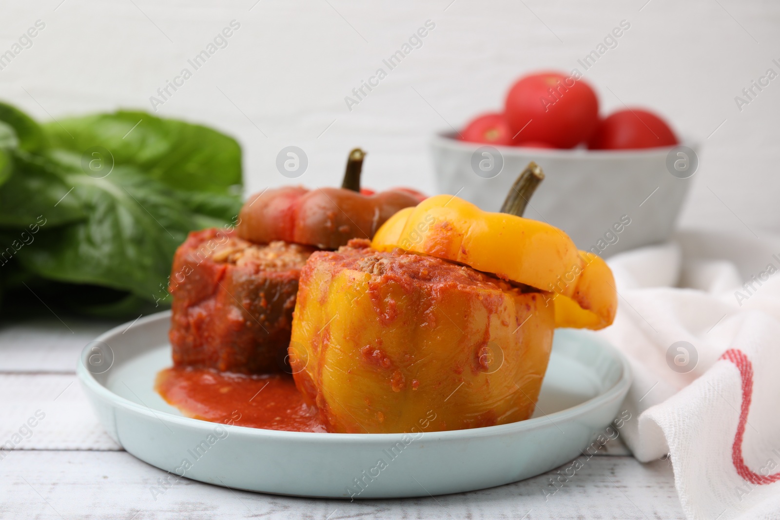 Photo of Delicious stuffed bell peppers on white wooden table