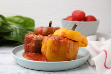 Photo of Delicious stuffed bell peppers on white wooden table