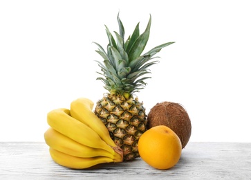 Set of fresh tropical fruits on wooden table