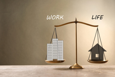 Image of Work-life balance concept. Scale with images of house and office building on table