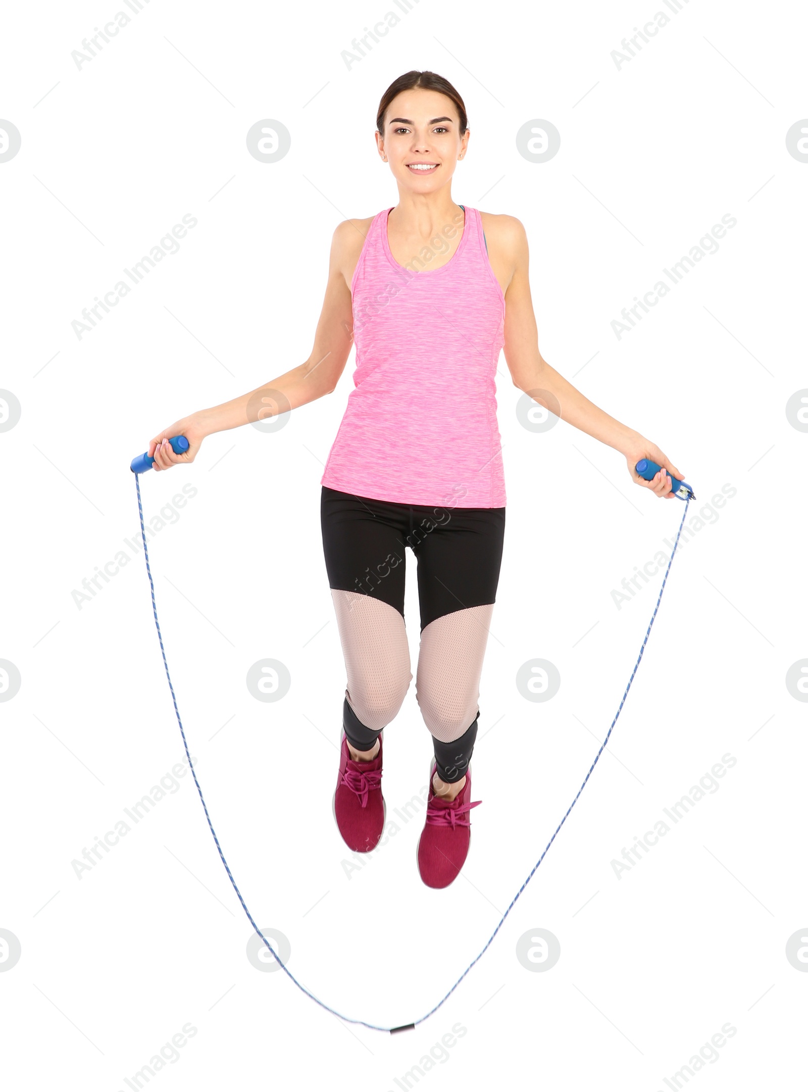 Photo of Full length portrait of young sportive woman training with jump rope on white background