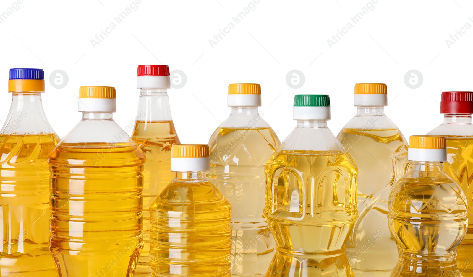 Photo of Bottles of cooking oil on white background