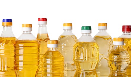 Photo of Bottles of cooking oil on white background