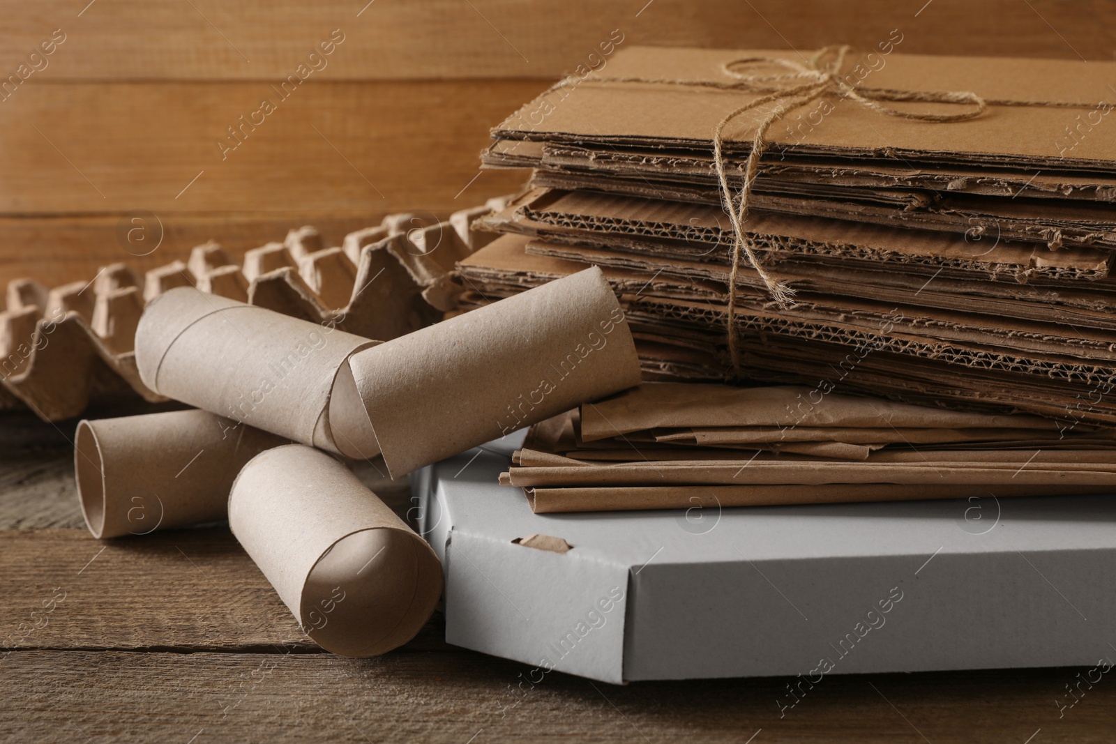 Photo of Different waste paper on wooden table, closeup