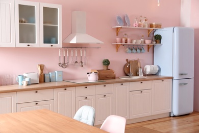 Photo of Stylish kitchen interior with counter and fridge