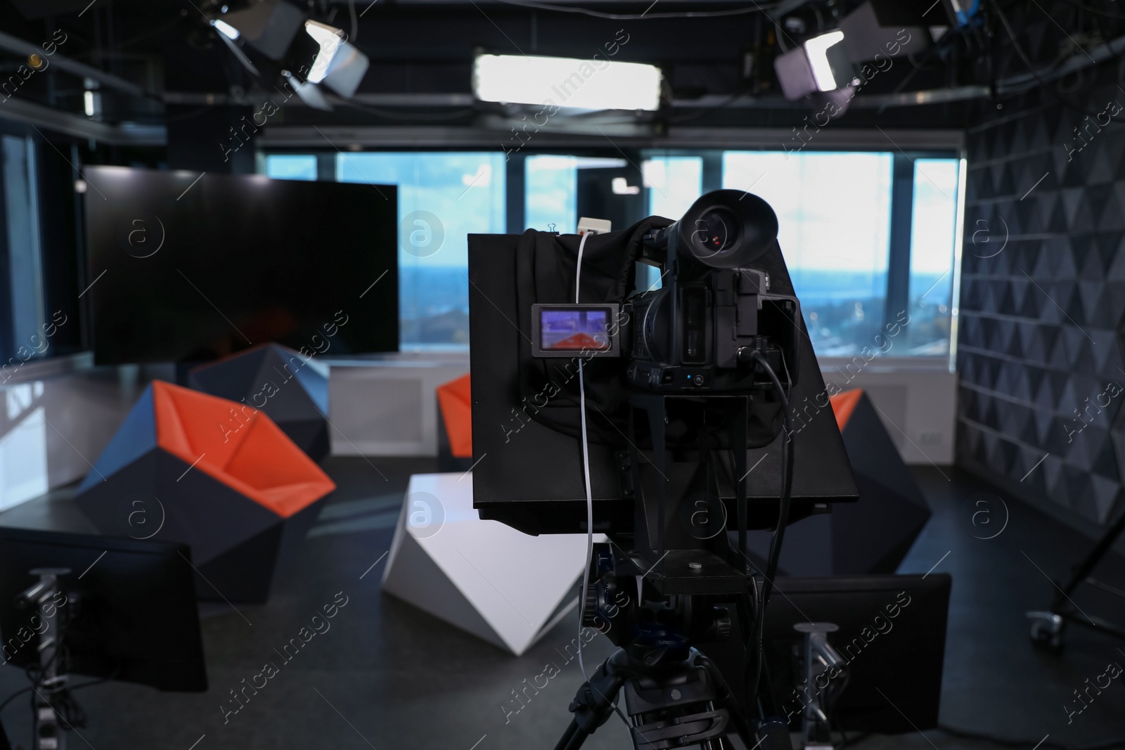 Photo of Modern video recording studio with professional equipment, focus on camera