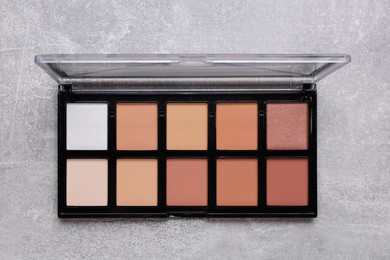 Photo of Contouring palette on light gray background, top view. Professional cosmetic product