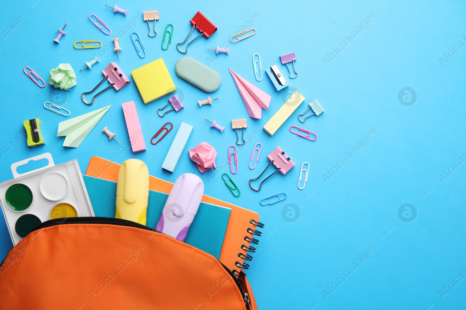 Photo of Back to school. Many different school stationery and paper planes on light blue background, flat lay with space for text